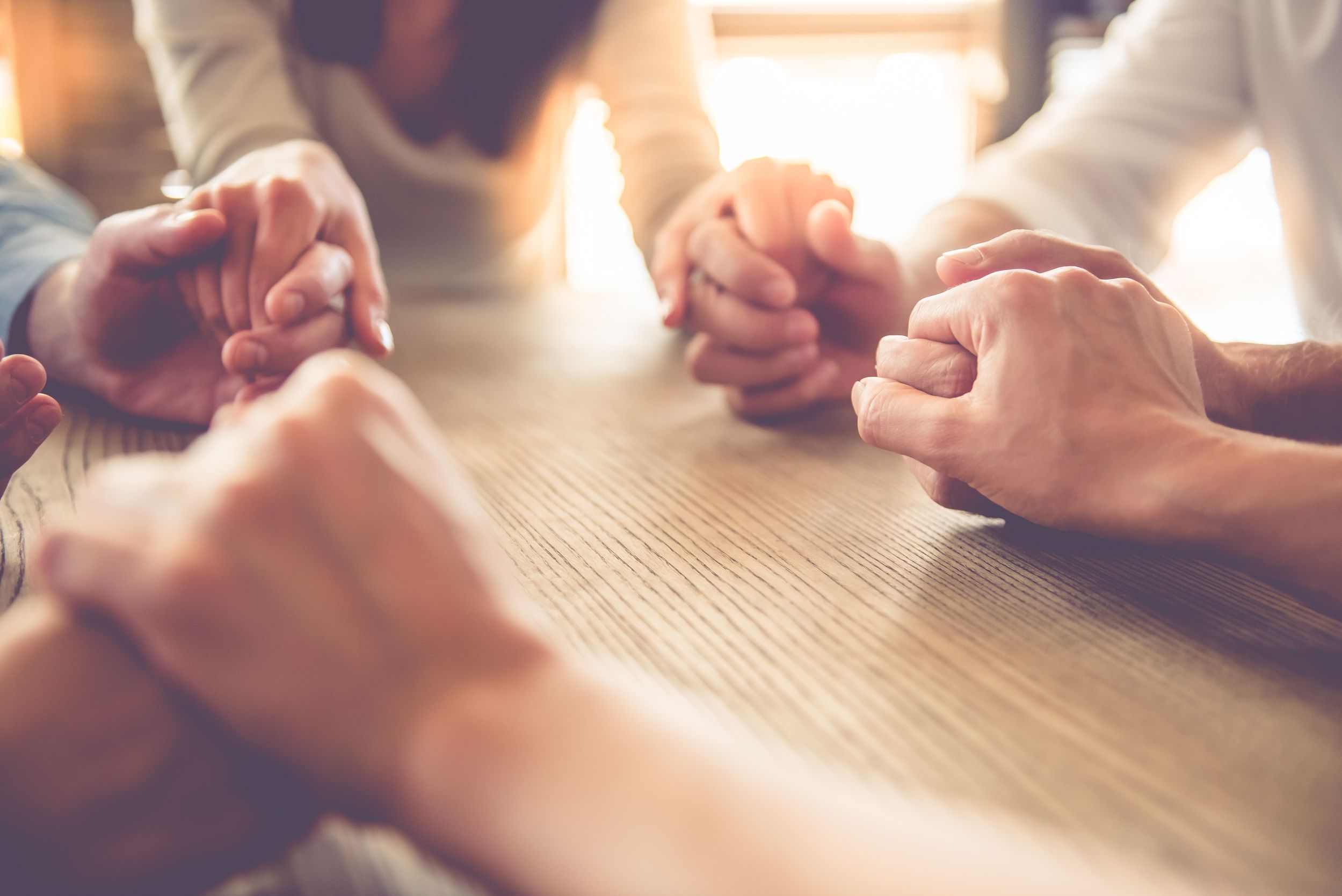 Hands joined together in prayer and support