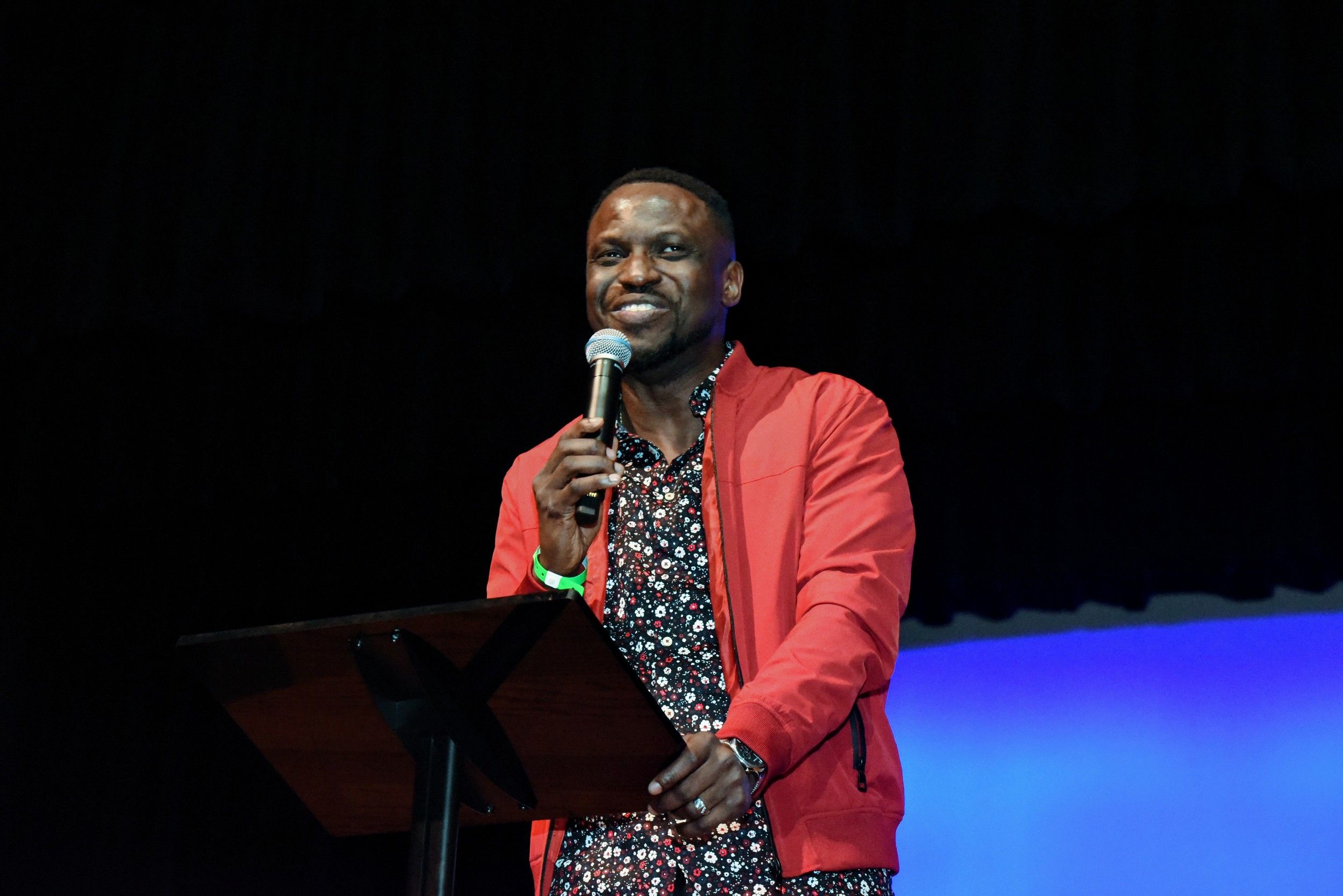 Man speaking on stage at Free Worshipper Church
