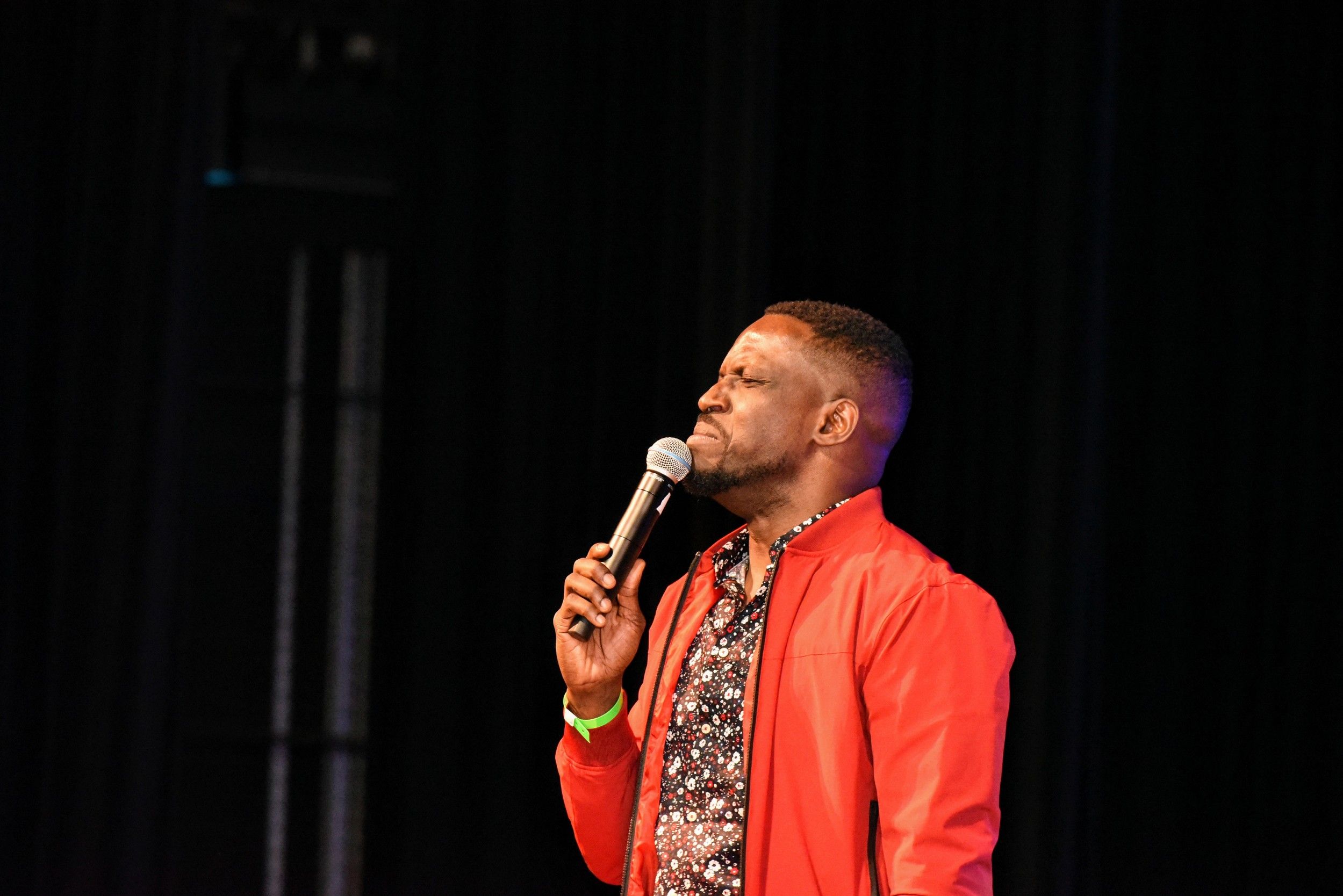 Man singing on stage with microphone