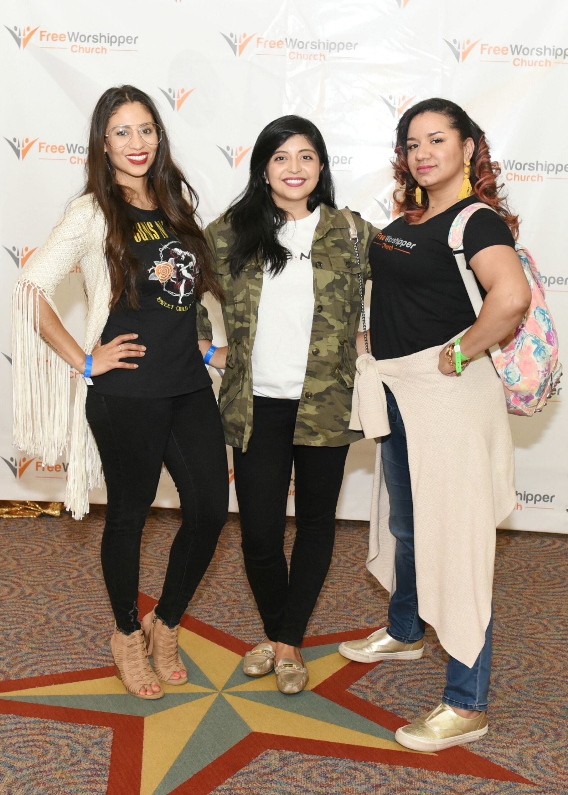 Three women smiling together at a church event
