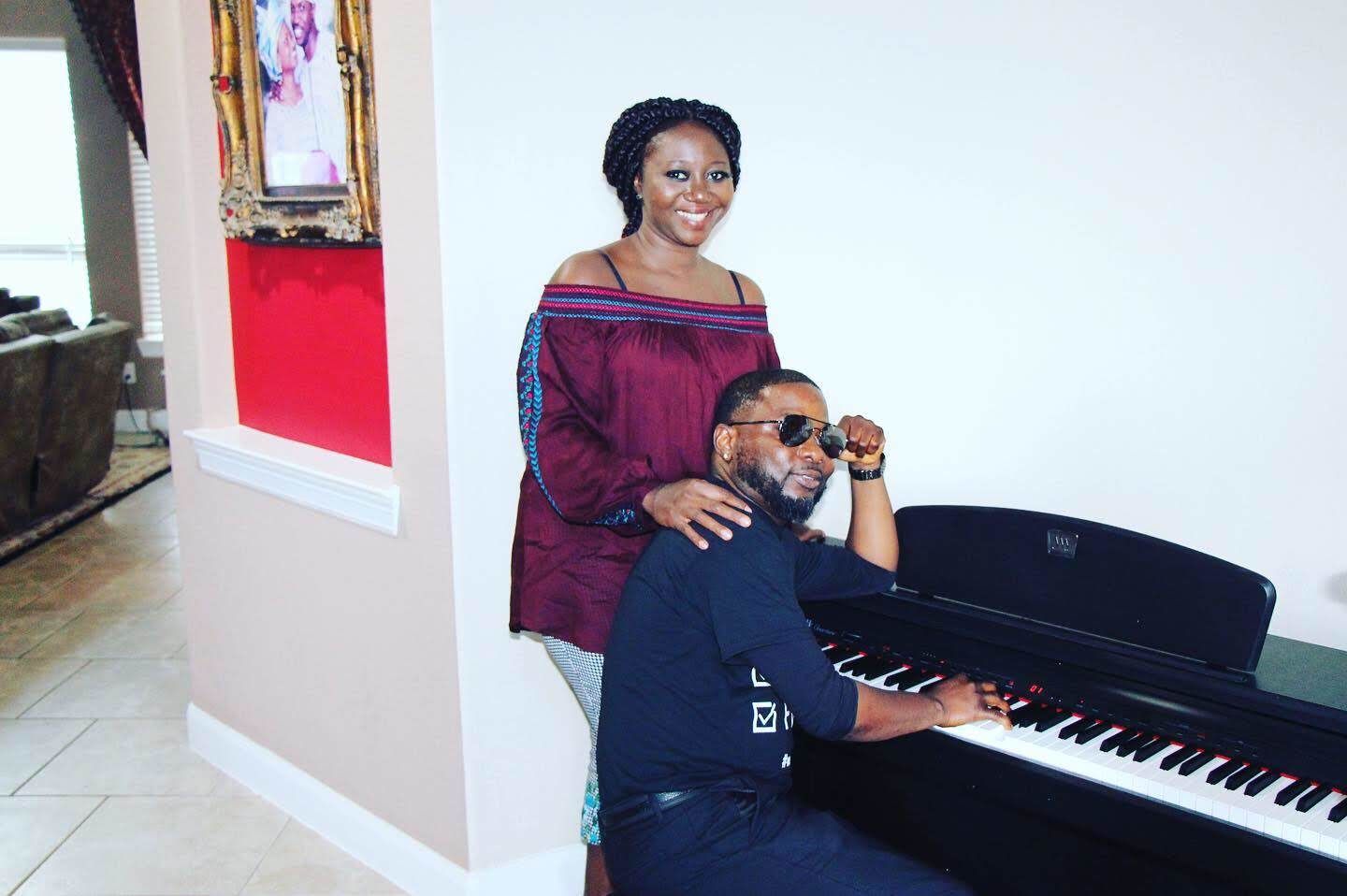 Couple posing by a piano in a home fellowship setting