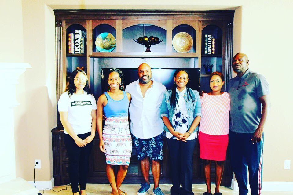 Small group standing together indoors during church fellowship