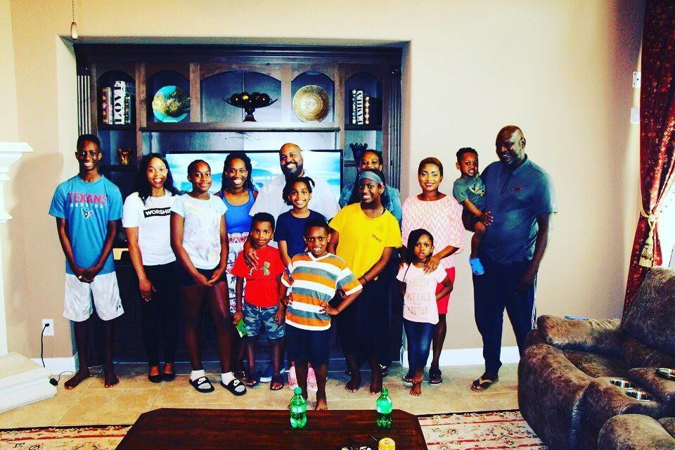 Families and children gathered together during a home church meeting