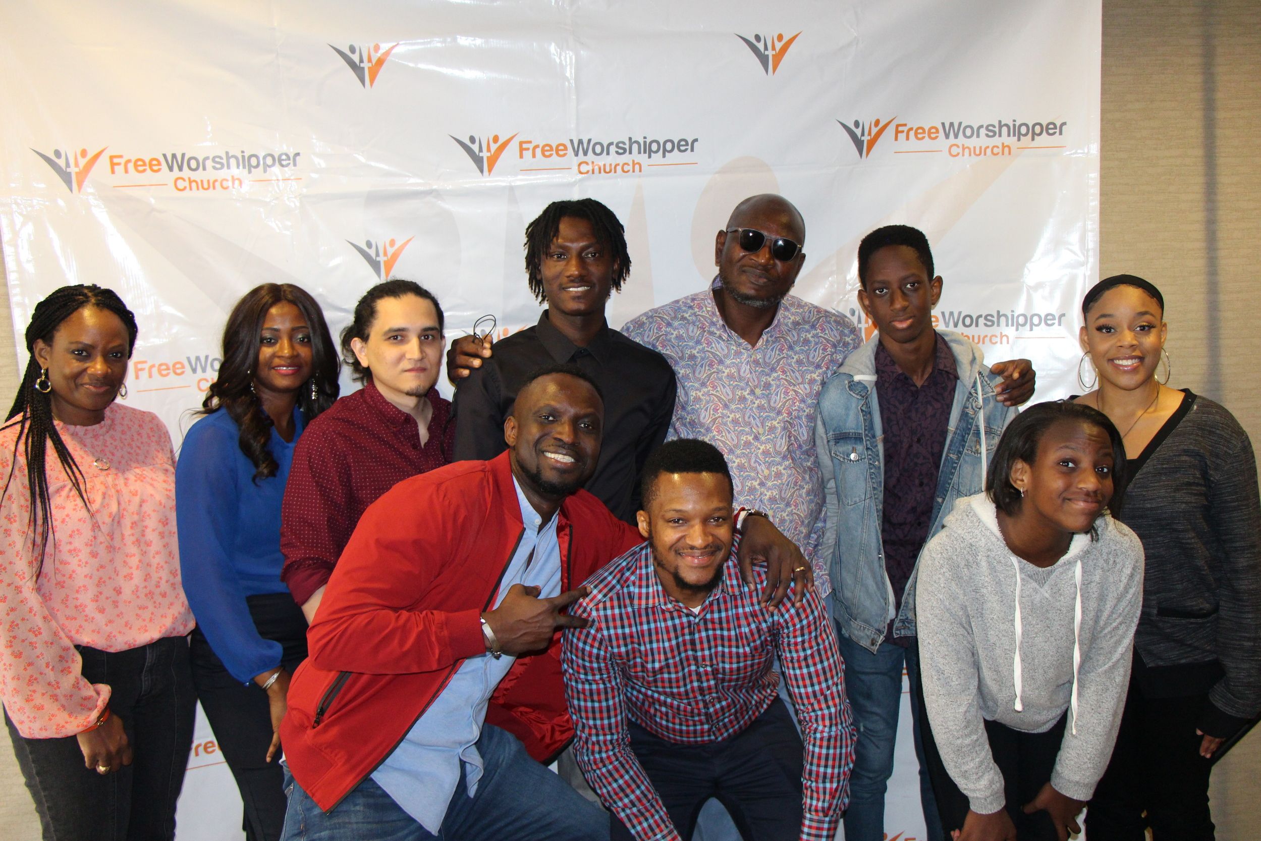 Large group portrait at a Free Worshipper Church event backdrop