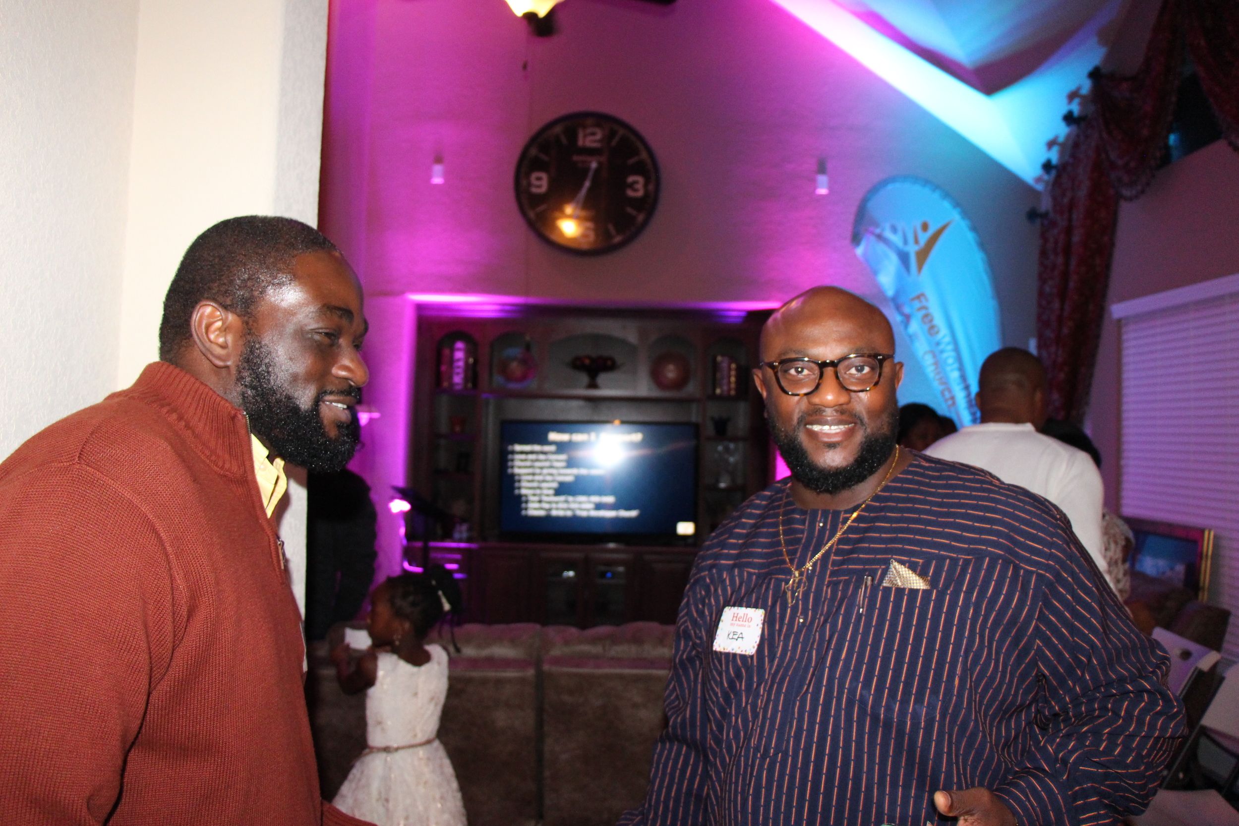 Two men talking together during a church meet and greet indoors