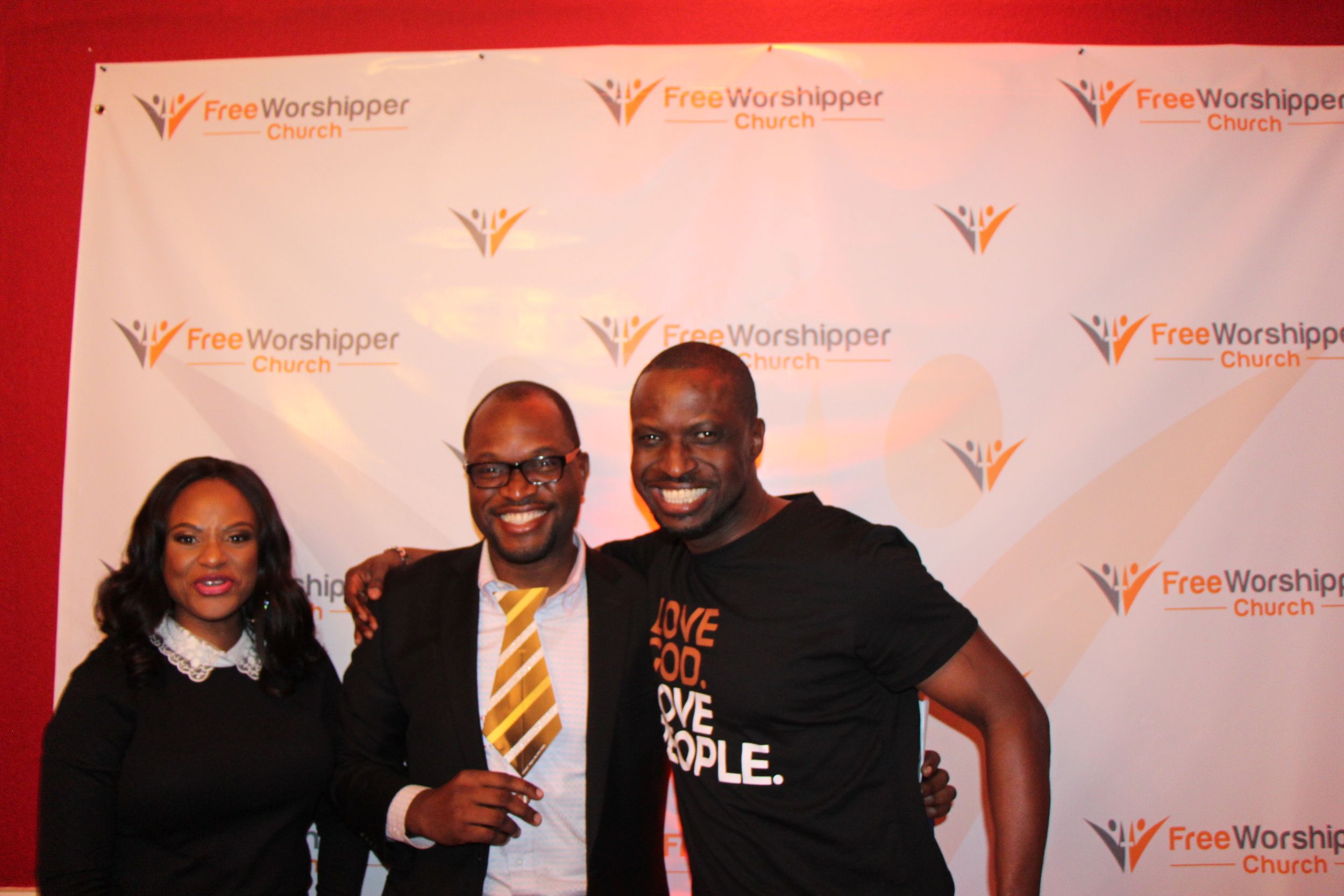 Three church guests posing together at the Free Worshipper Church meet and greet